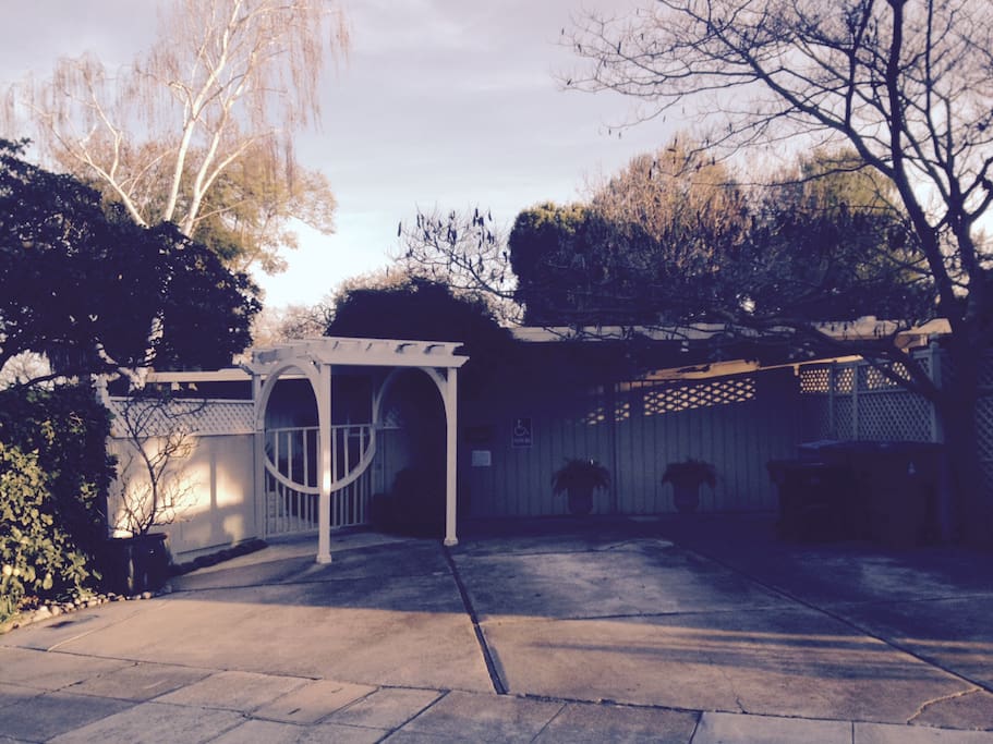 The view from the street. Large driveway with parking and enclosed front yard.
