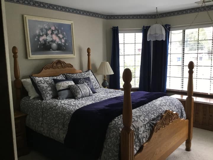 Queen Bedroom with lots of natural light and black out drapes