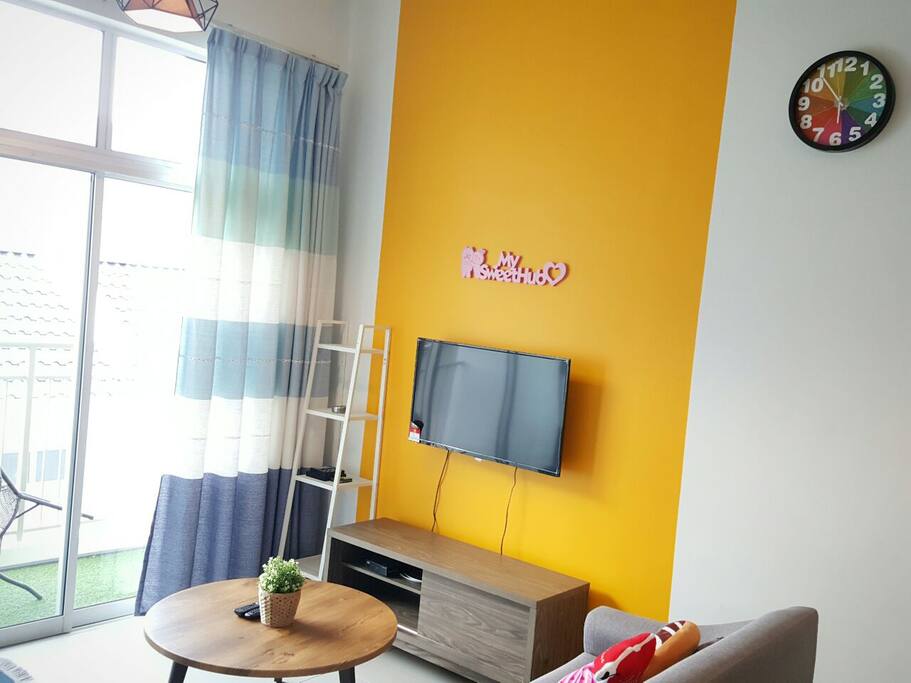 Living room equipped with our Television and colorful wall