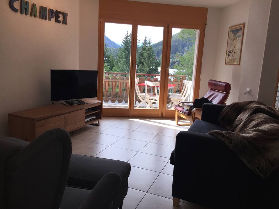 Living area with balcony view over lake
