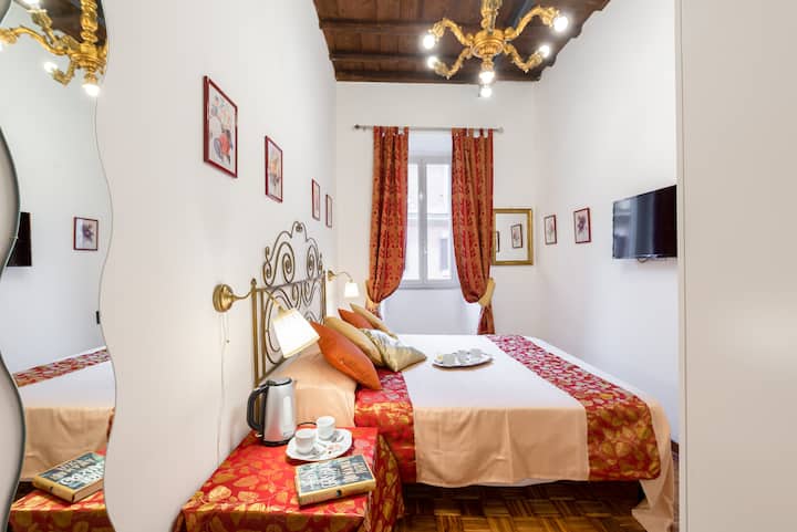 Segundo dormitorio doble, con armario con espejos,  antiguo candelabro de madera dorada, TV de última generación, dispositivo de humo,  wifi, aire acondicionado y ventana con vistas a la calle Sistine, a la derecha Piazza Barberini, a la izquierda, Trinita 'Dei Monti  