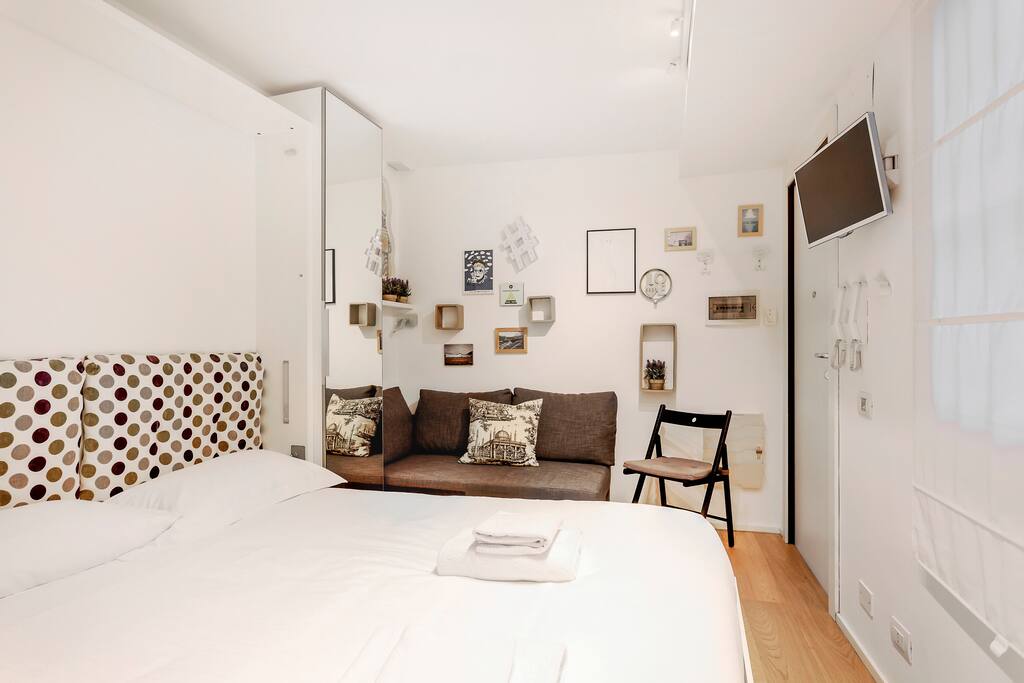 The living room (the dining table, the sofa and the double bed)