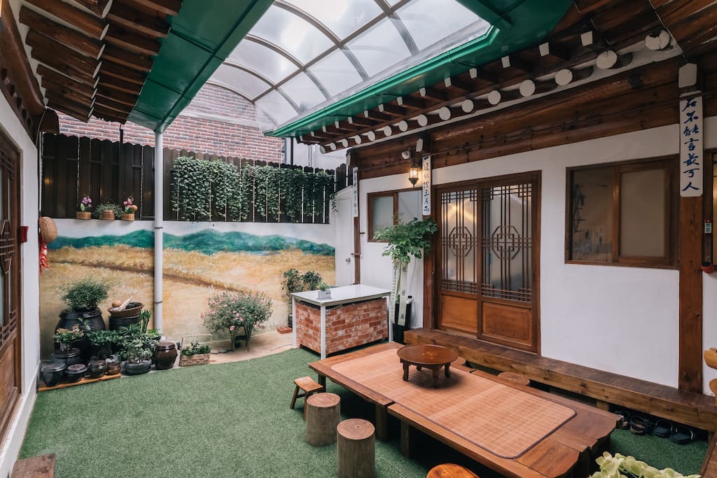 Inner yard with flat wooden bench and table is kind of living room where everybody can come together to talk and have a party