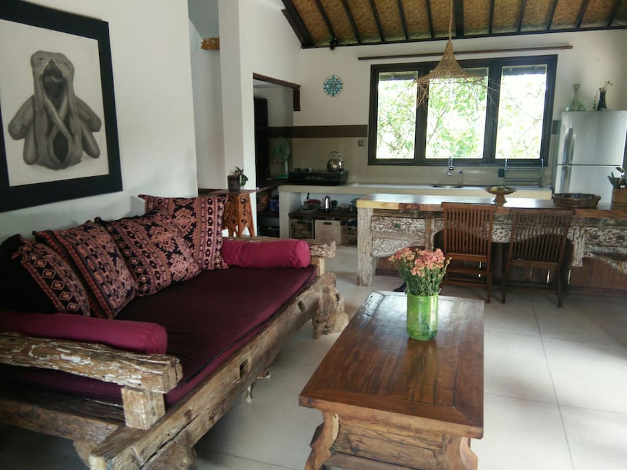 Living room with day bed and open fully equipped kitchen for all your needs