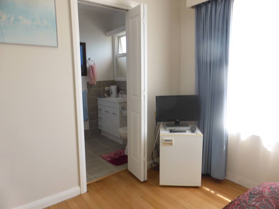 Mini fridge, TV & Foxtel (now wall mounted) doorway to ensuite