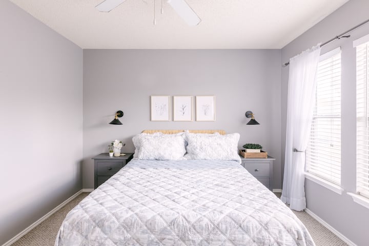 Bedroom two is located upstairs at the end of the hall to the left. It has a queen size bed with two end tables and a dresser. 