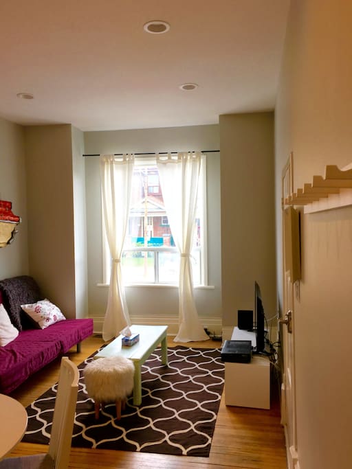 Bright open concept living room with 11 foot ceilings.