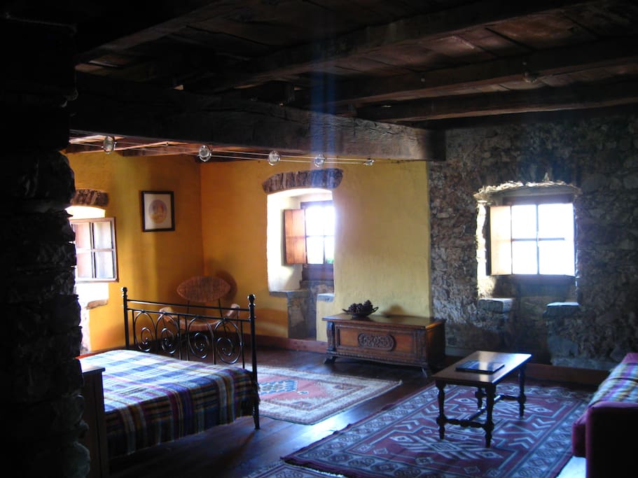 Large living area with original 16th century stone seats and ancient chestnut beams.