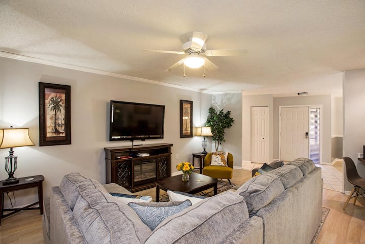 The stylish living room was recently remodeled to reflect a laid back tropical theme where mid-century cool meets modern style.