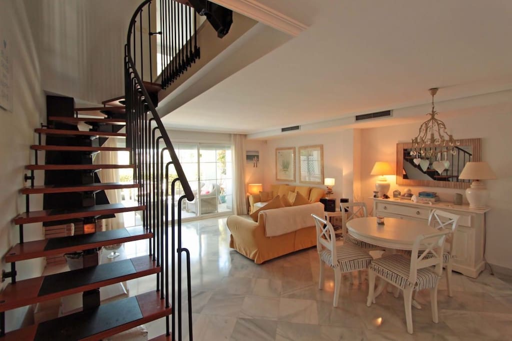 Living/dining room and stairs leading up to 1st and 2nd floor bedrooms.
