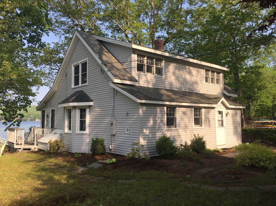 The front of the house, with the lake behind, and outdoor shower area