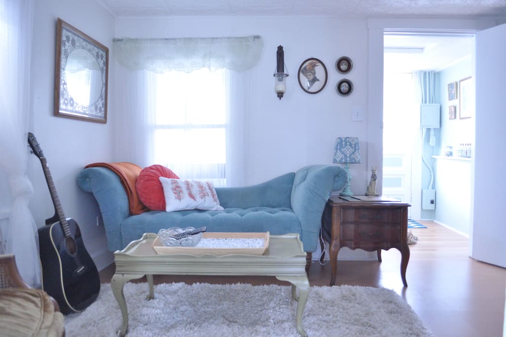 Living room with guitar for you to strum and small couch