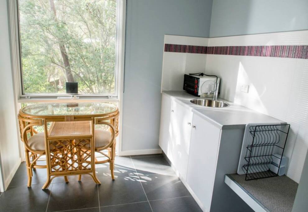 The separate kitchette has a microwave oven, crockery and cutlery, dining facilities and a refrigerator.