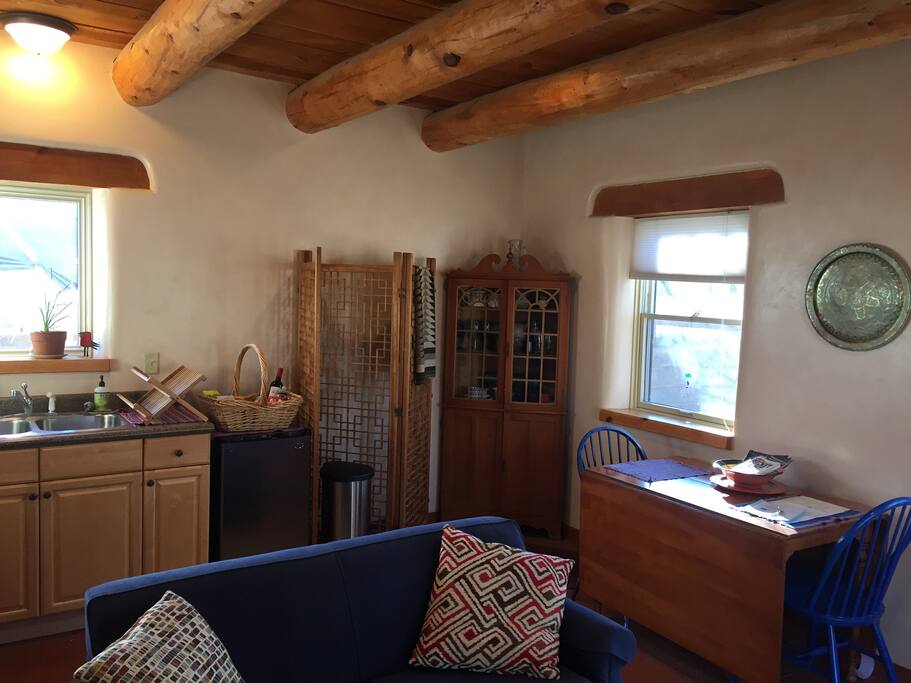 The living room has a couch with foldout single bed, small kitchen, dining table and chairs. Free guest WiFi is included.