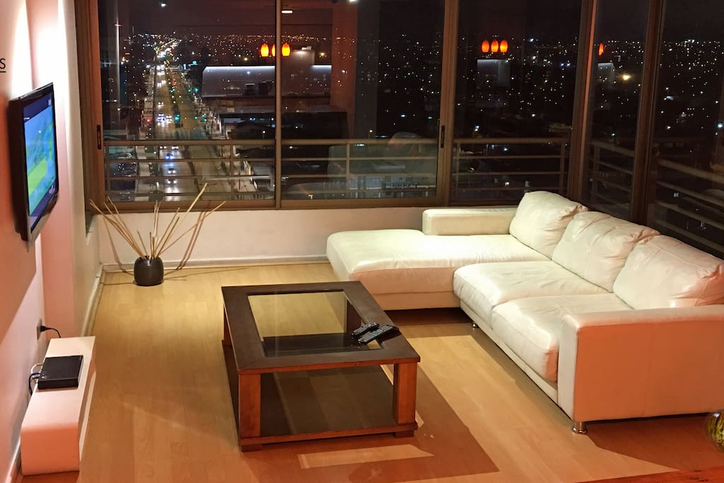Amplia sala con vista panorámica de 270º, con cómodo sofá de cuero y TV LED de 40" con programación satelital HD, 32" en dormitorio principal.