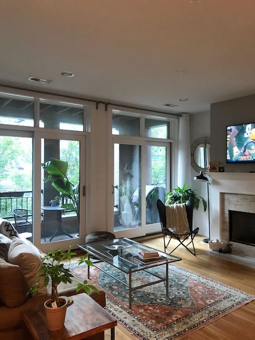 Living room with plenty of natural light, double door access to patio, cable TV, and gas fireplace.