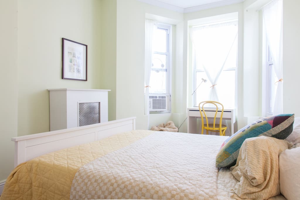 The bedroom is facing a quiet street, with a beautiful bay window and desk. There's also an AC for you to use. A