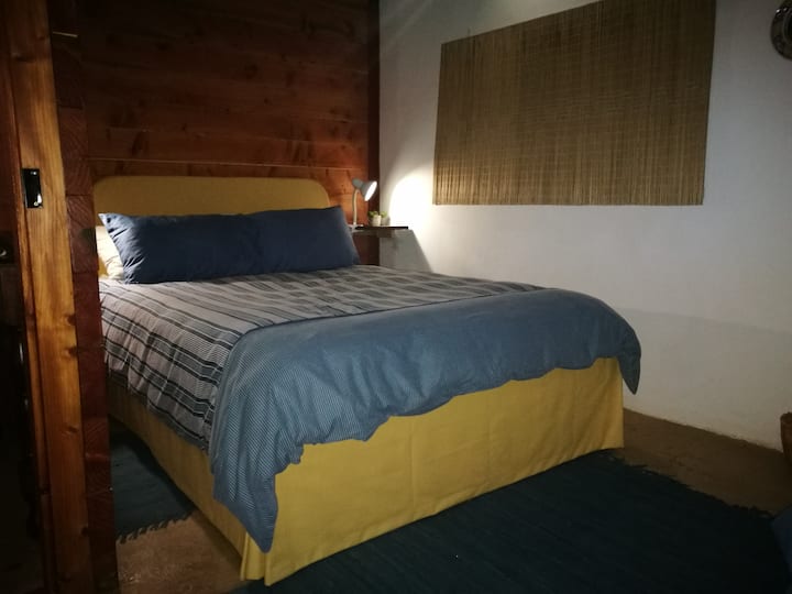 Second bedroom with one double and another single bed