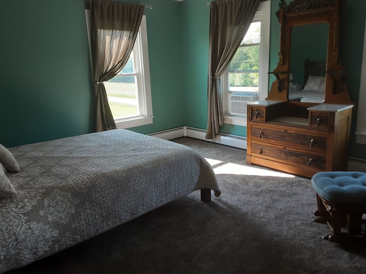 Queen bed in upstairs bedroom.