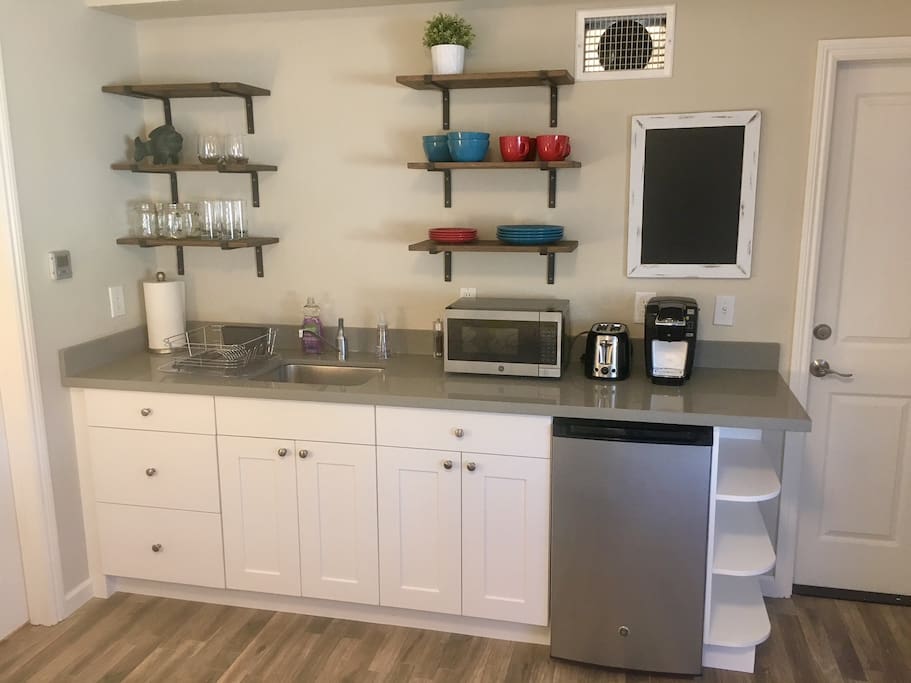 Kitchenette with mini fridge, microwave, Keurig coffee machine, and toaster
