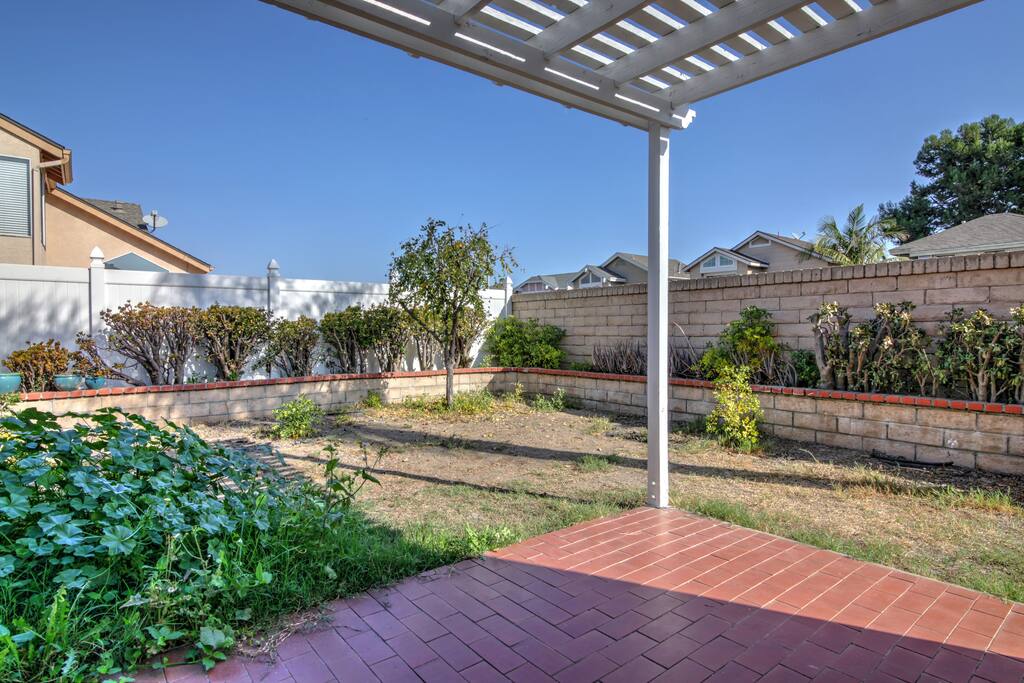 A tiled patio and fenced-in yard await out back