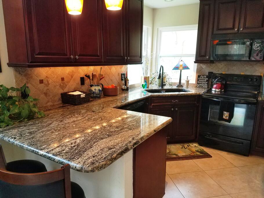 Kitchen with mahogany cabinets & granite.