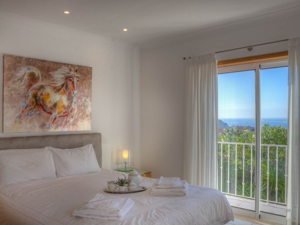 This stunning room has seaviews a balcony, an en suite bathroom, and patio doors leading on to a shared upstairs roof terrace. 