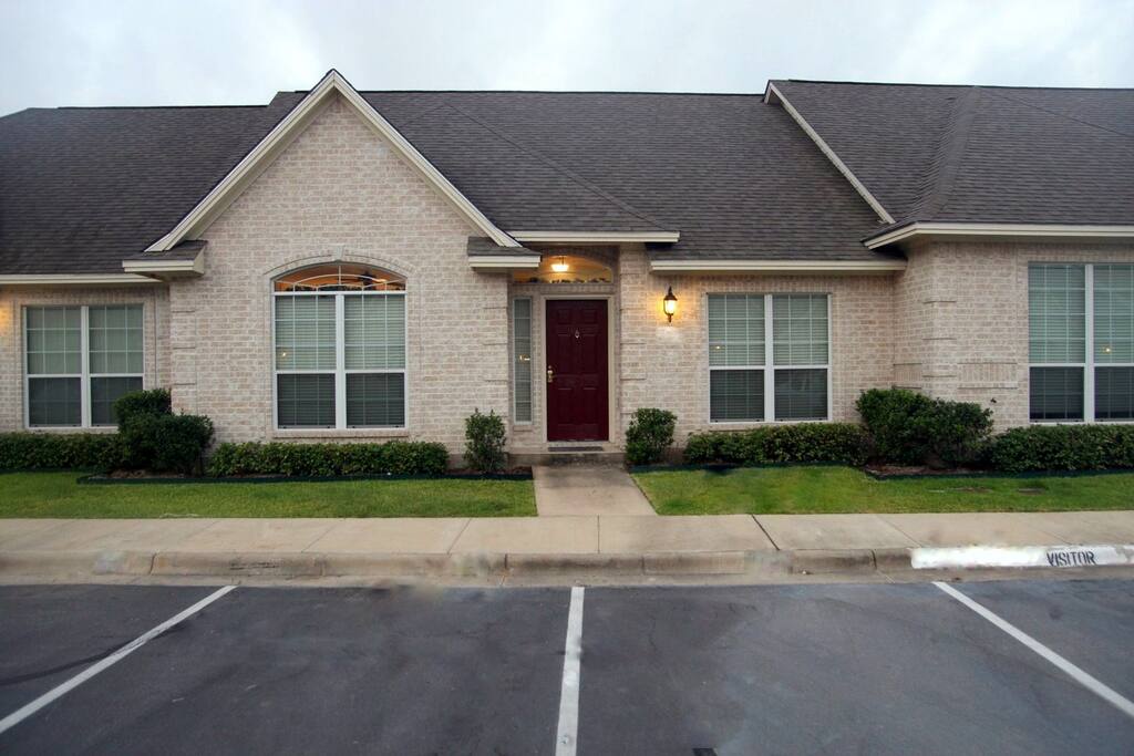 Front of condo showing 3 parking spaces