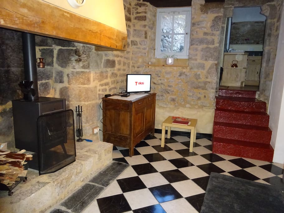 Breton fireplace, antique sideboard and steps up to kitchen