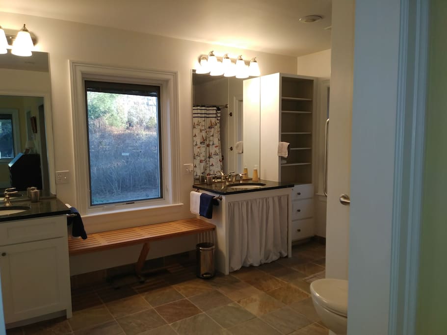 En-suite bathroom, with 2 separate vanities, large walk-in shower, handicap equipped, and spacious.