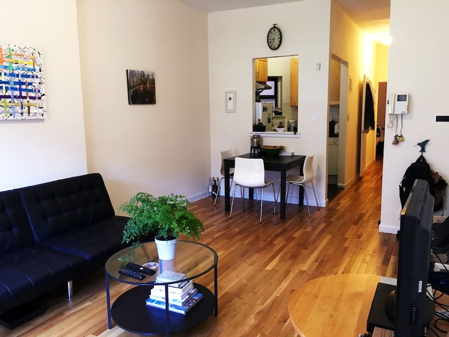 View of the living room, kitchen, and hallway leading to bedroom