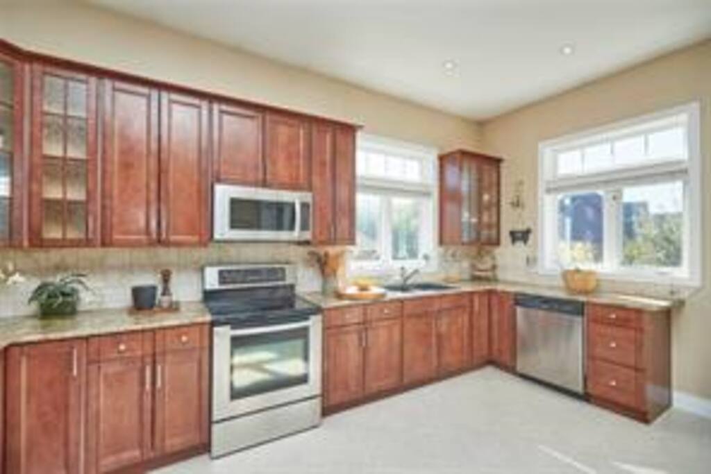 Plenty of room for multiple people to cook their favorite meals together. Door leading to back deck.