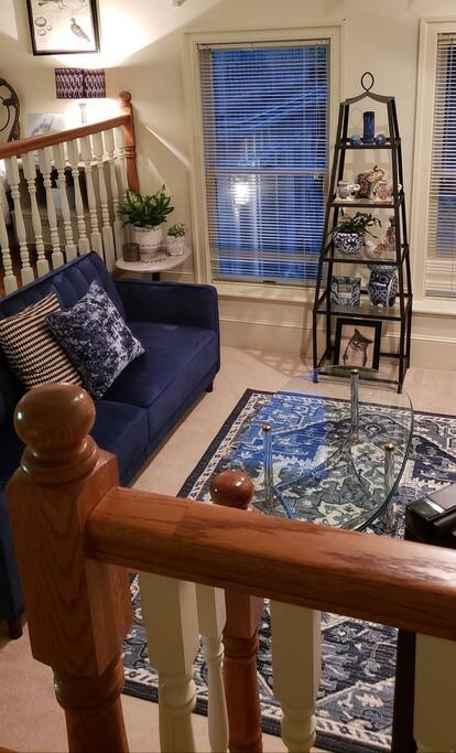 Comfortable sunken living room with large fireplace and direct tv.