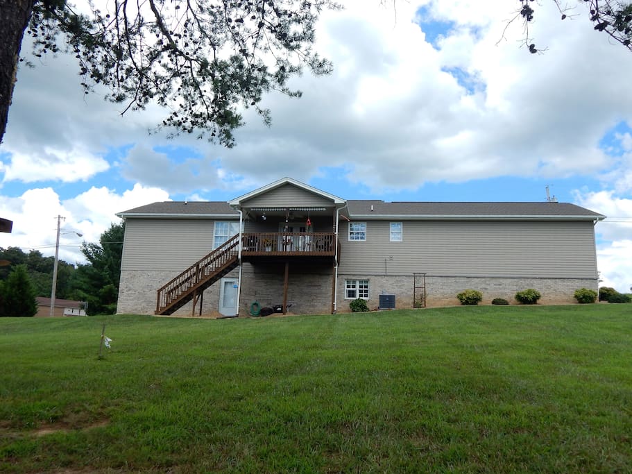 Back of home, private entrance under deck.