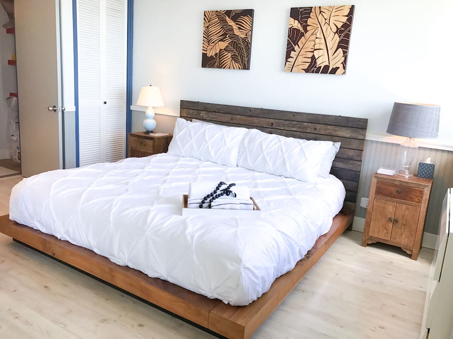 Spacious bedroom features a king sized bed with a memory foam mattress