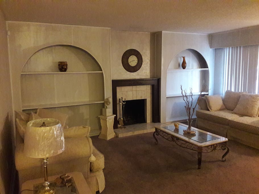 Living room with fireplace and decorative shelves