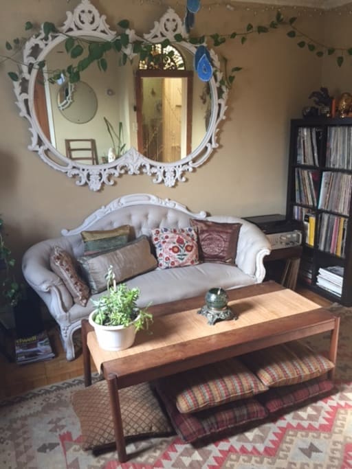 Vast record collection and floor pillows for lounging or working at table