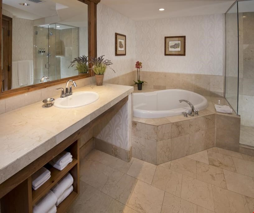 Prepare for the day in the luxurious marble bathroom.