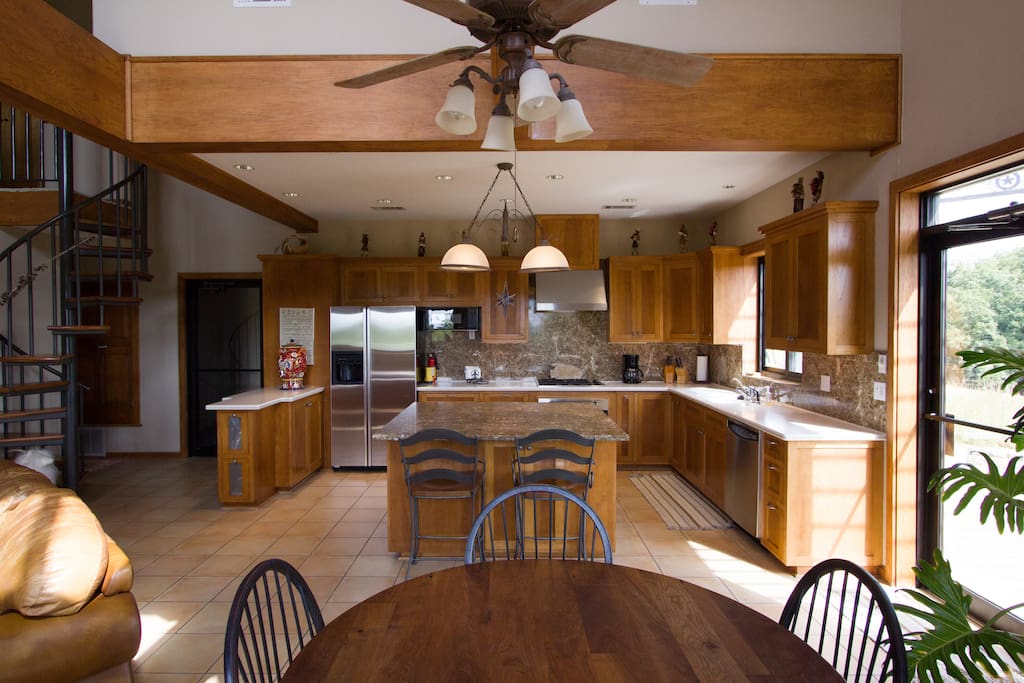 Spacious kitchen overlooking the vineyard for serene meal peparation.