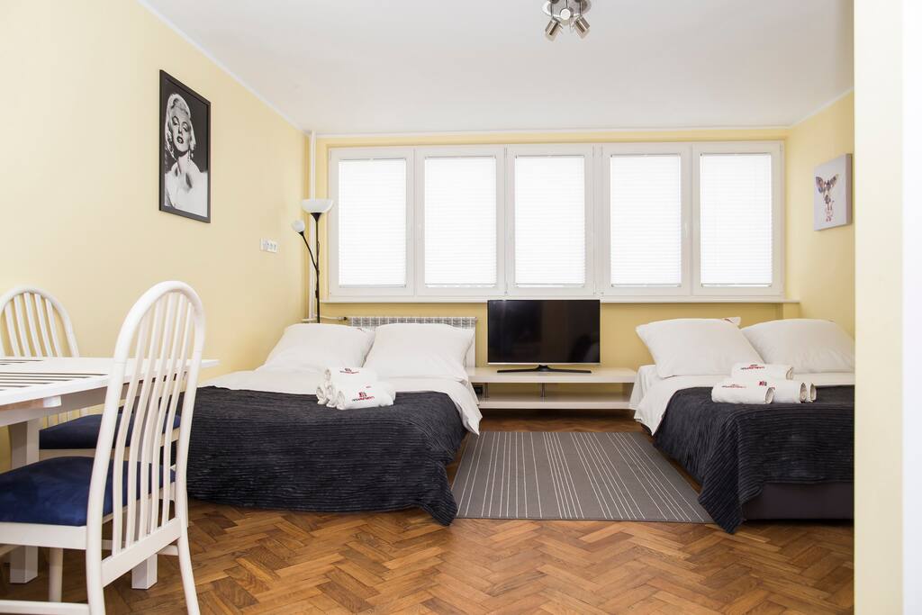 Studio with two double beds and TV.