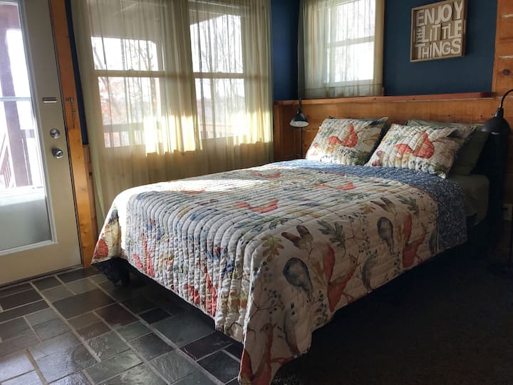 Lower level bedroom with queen bed.  Wake up and step right outside to the deck and the hot tub!
