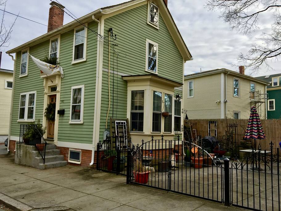 The Eclectic Charmer view from the street and gated parking for 2 cars until May 1st then patio with room for one car!