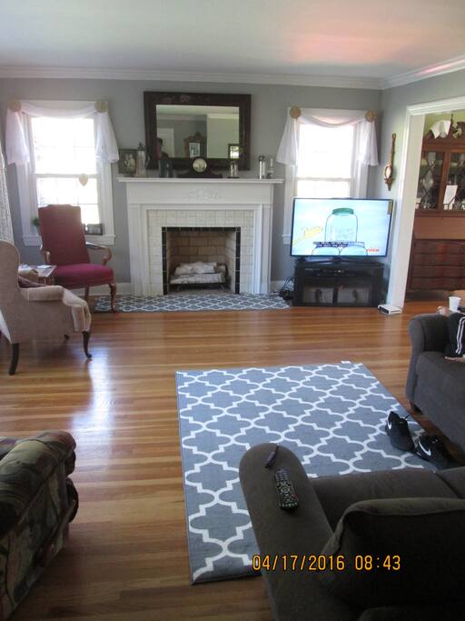 Living room view. Living room has a 50 inch tv, a couch that sits 5 and 3 chairs. We can bring another chair in if you would like.