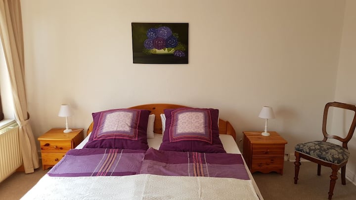 Bedroom with double bed and walk-in closet.