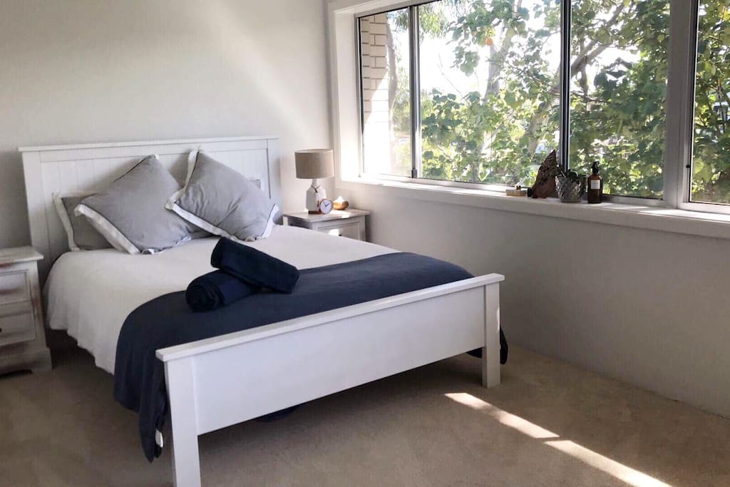 Cozy nautical queen bed for a good night's rest. Big room with a wide window overlooking a relaxing river and allowing the cool Australian air breeze.