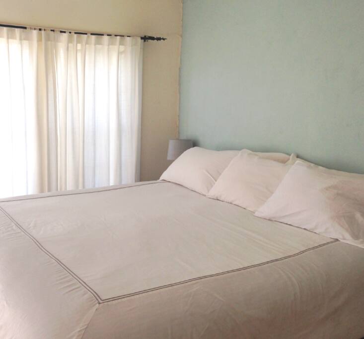 The super comfortable California King bed in the master bedroom full of soft natural light