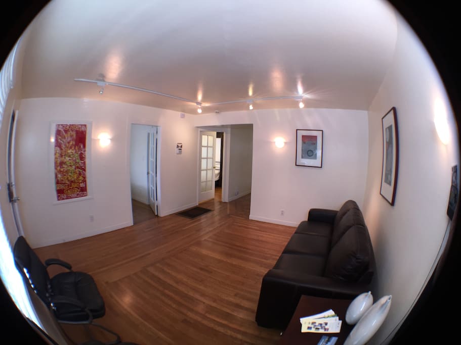 Living room as you walk into house. To the left are the two bedrooms. Through the hallway is the dinning room on your right and the kitchen straight ahead.