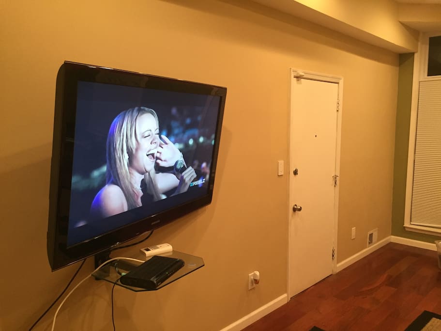 60 inch screen television in living room with cable.