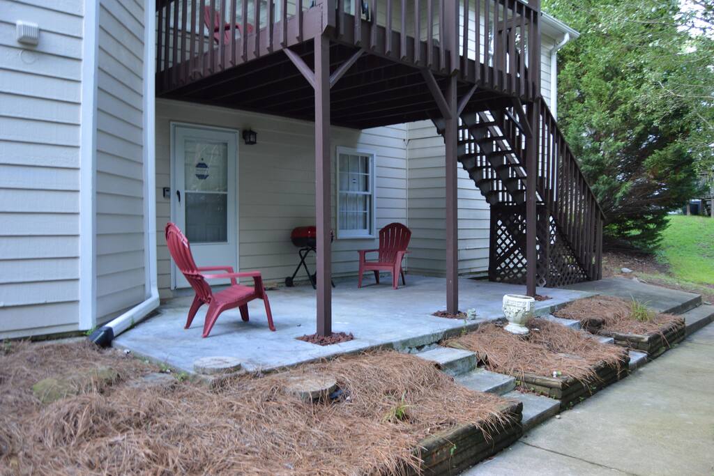 Rear private entrance with patio and grill.