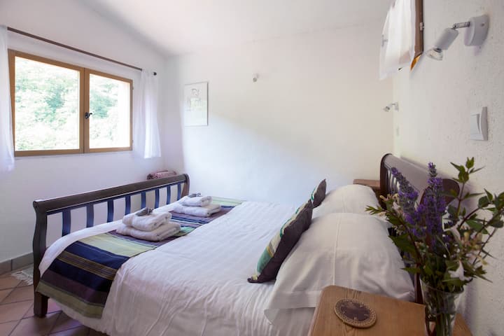 A room with a view of chestnut forest, and with space for a small cot.